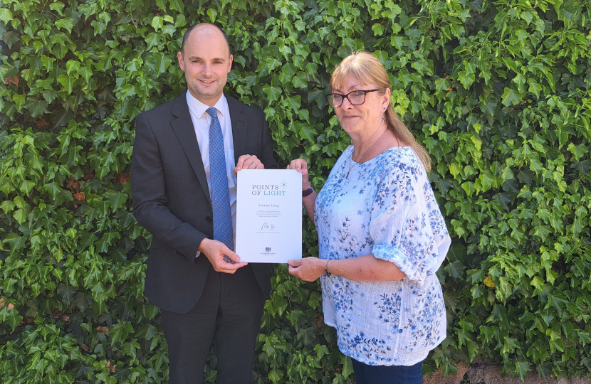 Jeanne Long receiving her Point of Light Award from Luke Hall MP 